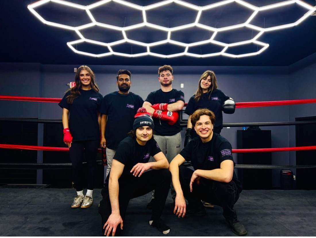 Six people in Rallying for Robert shirts posed in a boxing ring.
